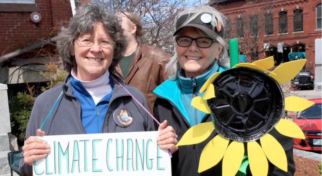 Two older women protesting climate change